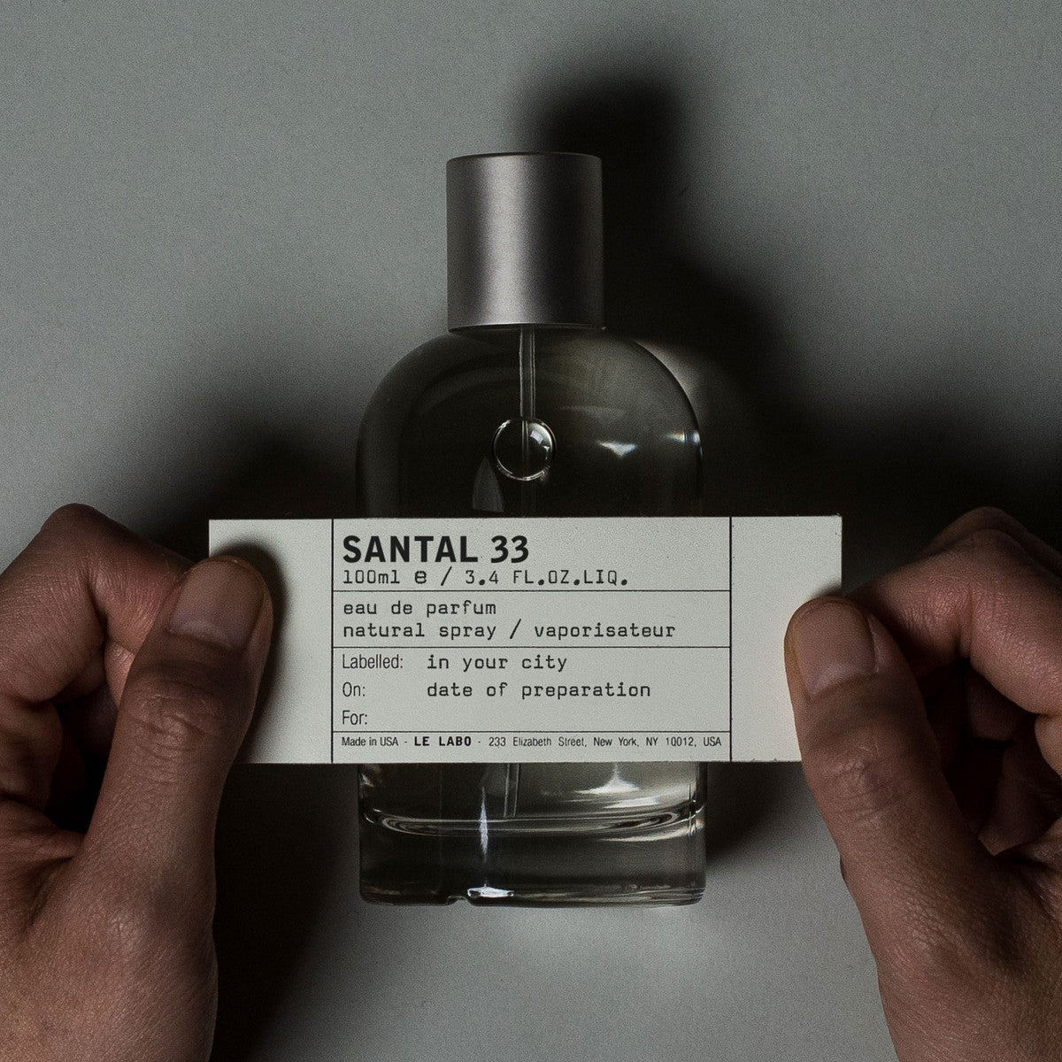 Santal 33 by Le Labo Eau de Parfum 100ml bottle, a unisex woody fragrance with notes of sandalwood, cardamom, iris, and violet for a bold, long-lasting scent.